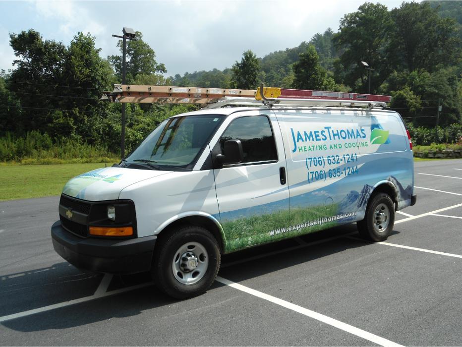 Branded James Thomas Heating and Cooling service van parked in a lot, ready for residential HVAC service calls.