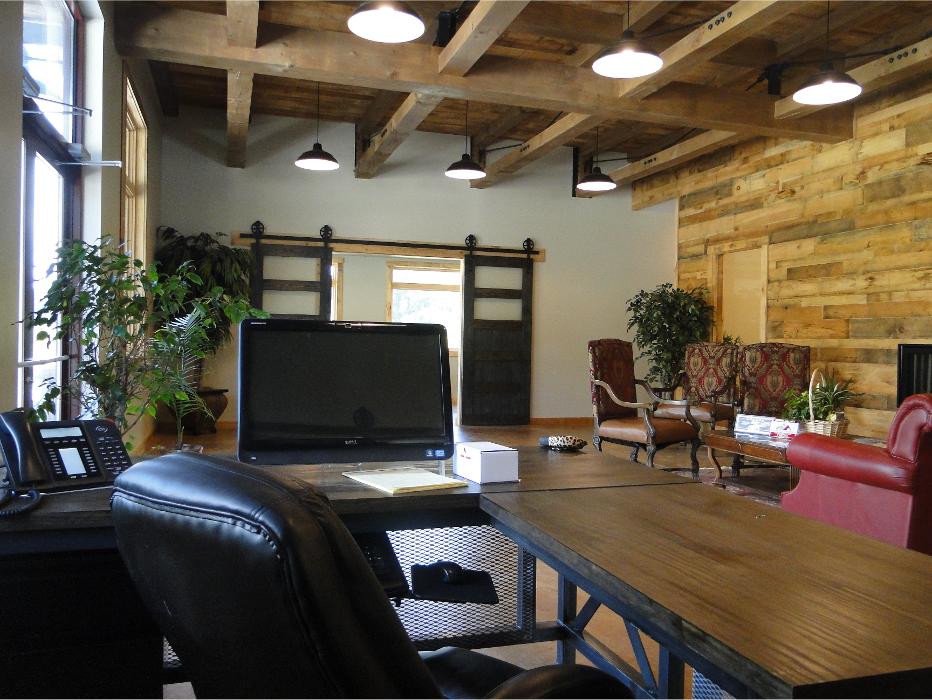 Comfortable indoor office or showroom space with wood finishes, seating, and a welcoming atmosphere.