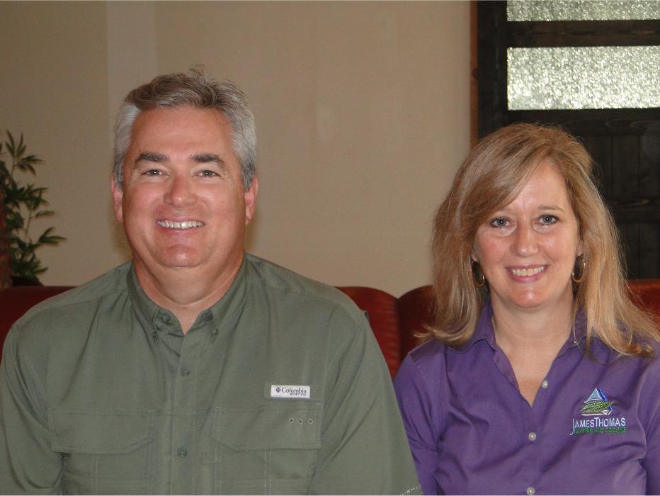 Portrait of two team members smiling indoors, representing the friendly faces behind the company.