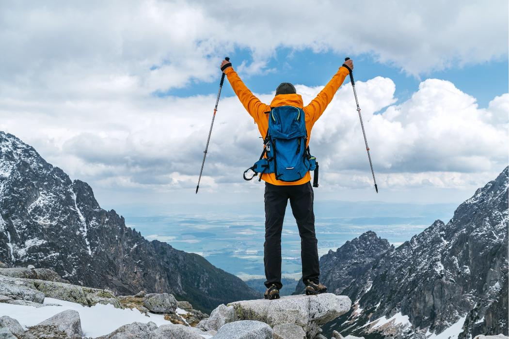 A person standing outdoors in snowy mountains, representing visitors enjoying high-altitude destinations where supplemental oxygen may help with altitude adjustment.