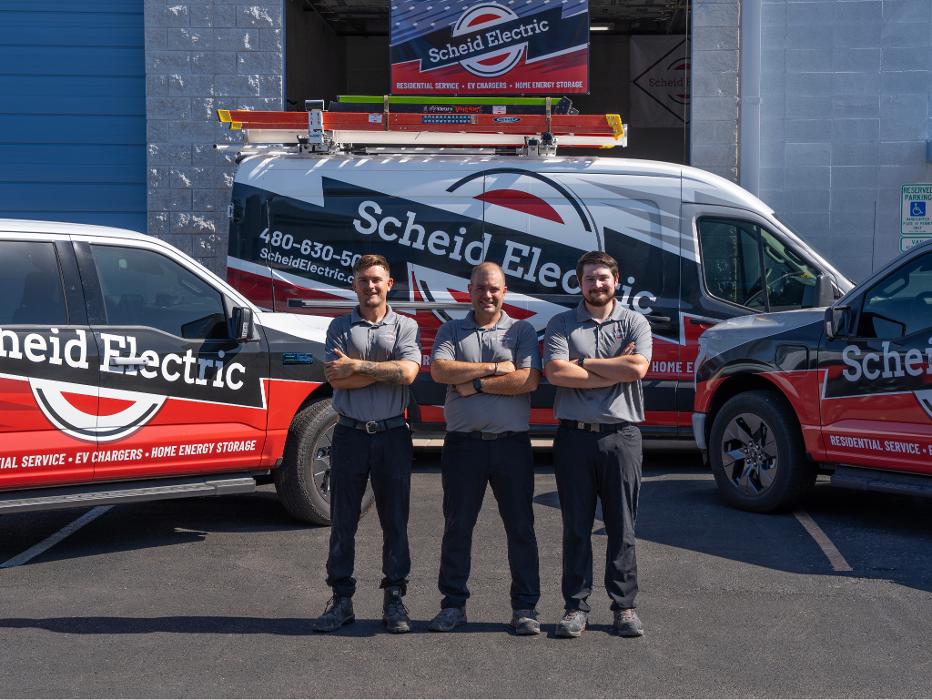 Scheid Electric team standing with service vehicles ready to deliver electrical solutions in Queen Creek and the East Valley.