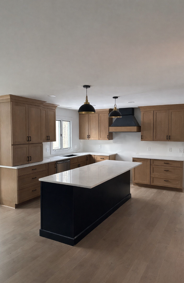 kitchen remodel in Grand Rapids, MI featuring a large island, custom wood cabinetry, and clean contemporary finishes by Grand Rapids Contracting.