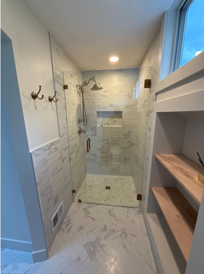 bathroom remodel in Kentwood, MI featuring custom tile work, updated fixtures, and clean, high-end finishes by Grand Rapids Contracting.