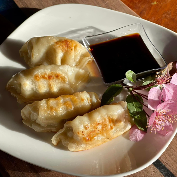 Pan-fried Thai dumplings with a crispy exterior and savory filling, served with dipping sauce&mdash;an easy favorite for a quick bite near Highway 7 in Lafayette.
