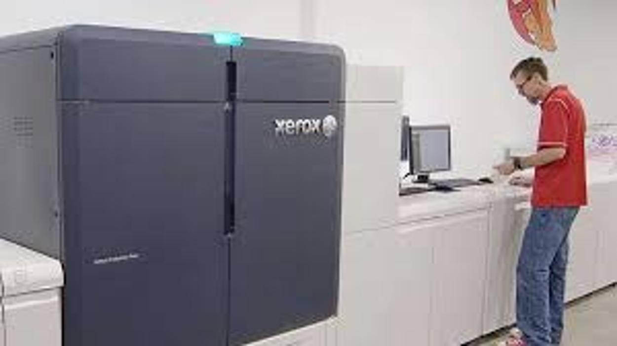 Xerox Iridesse production printer in use by a professional operator, showcasing high-quality, high-volume printing, advanced color capabilities, and reliable production solutions for business and commercial environments.