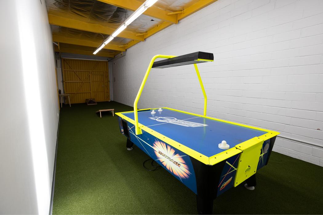 A dedicated recreation room at Key Healthcare Adolescent Outpatient featuring an air hockey table, providing teens with a fun, active space to unwind and build peer connections.