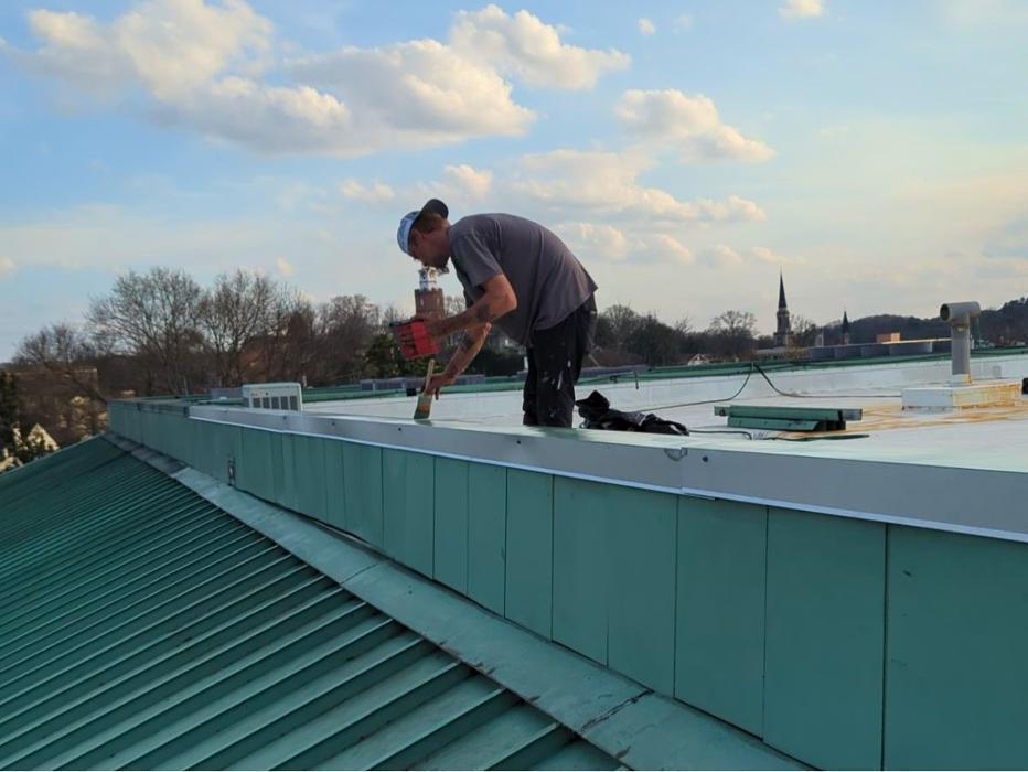 Here we are applying a protective edge sealing where a flat membrane meets a standing seam metal roof. Proper maintenance on seams and flashing is a standard process to help prevent leaks and extend the overall life of the roof.