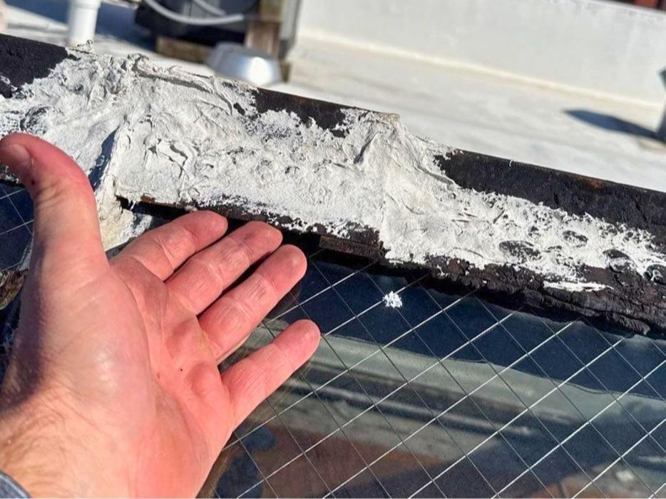 Improper roof repairs, like using excessive caulking on a rusting skylight, often fail to stop active water leaks long-term and can trap moisture. Our team identifies failing roof seals and provides proper repair and replacement options.