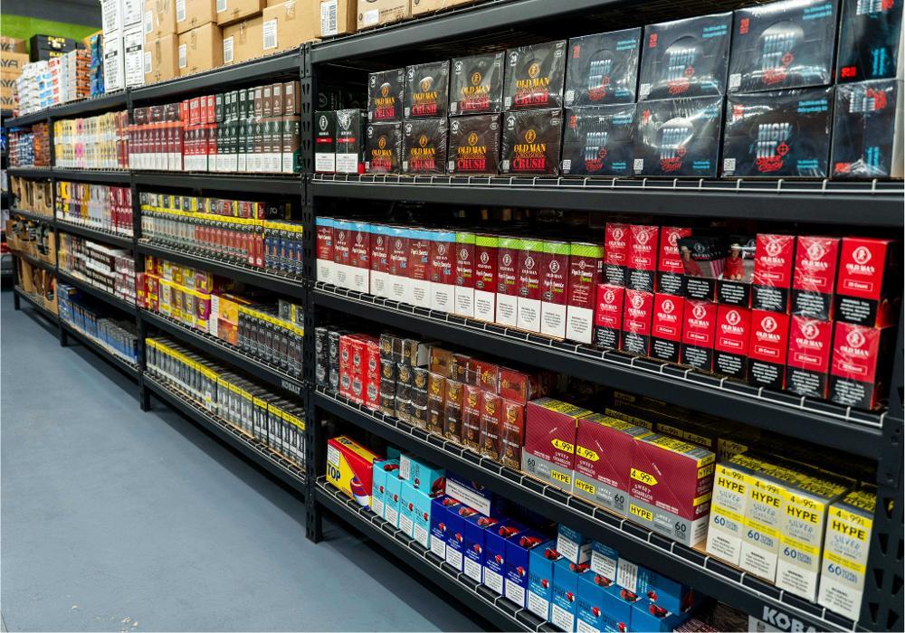 Fully stocked wholesale shelves with beverages, snacks, and retail products ready for distribution to Boston area businesses.