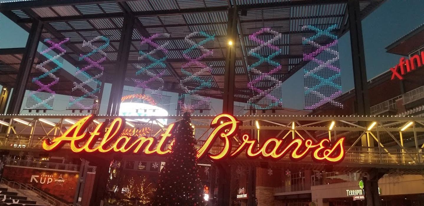 A vibrant custom neon sign installation glowing above a lively interior space, adding bold character and visual impact to the venue.

