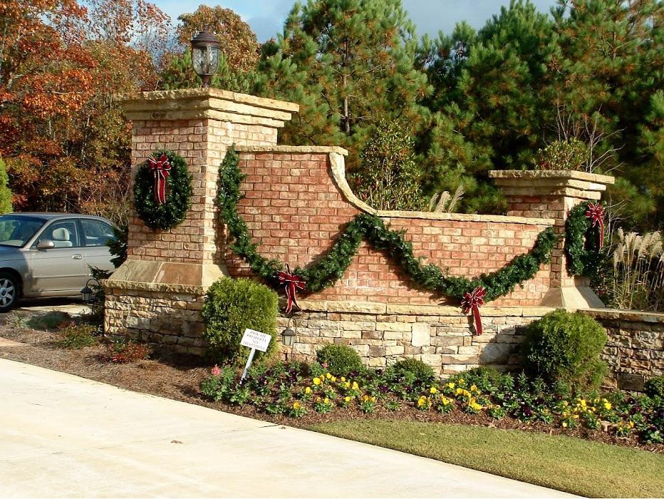 An elegant residential entrance decorated with lush garlands, wreaths, and holiday greenery for a warm and festive welcome.