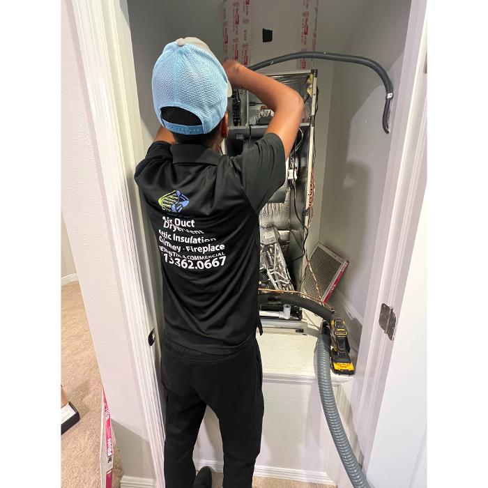 Clean Air Pros FL technician using professional equipment to clean ductwork and improve indoor air quality in the home.