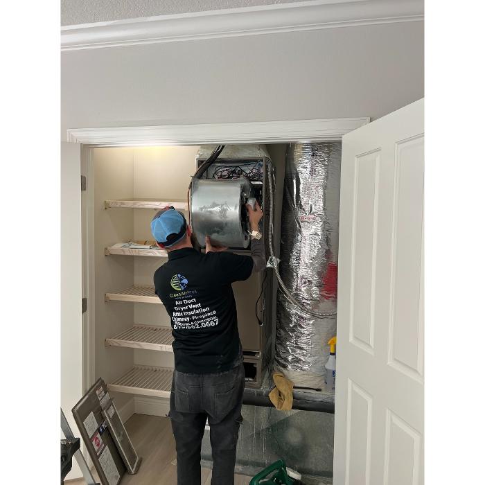 Clean Air Pros technician servicing interior ductwork in a home to remove buildup and improve HVAC airflow and indoor air quality.