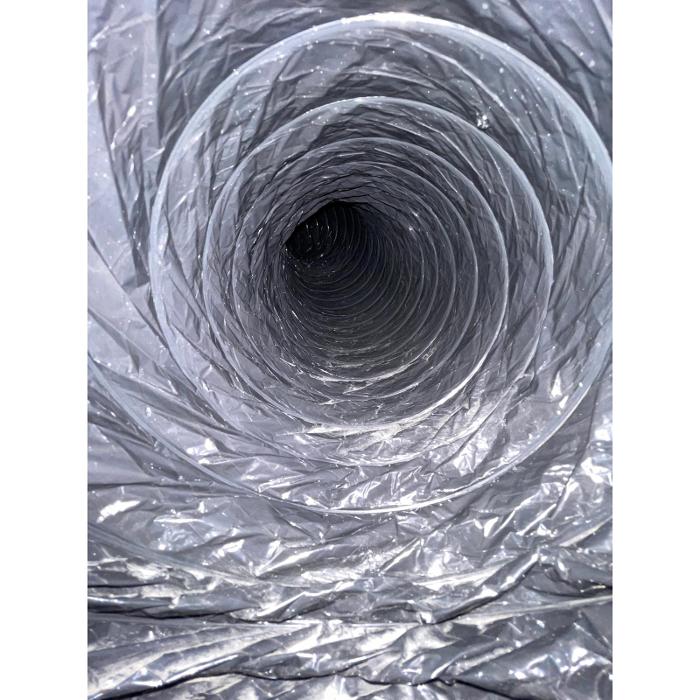 Interior of a silver flexible air duct, highlighting the depth and condition of the ductwork as part of professional air duct cleaning services.