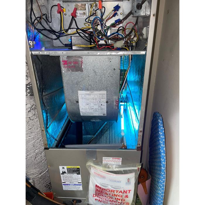 Residential HVAC unit and service equipment prepared for air quality improvement, duct cleaning, or system maintenance.