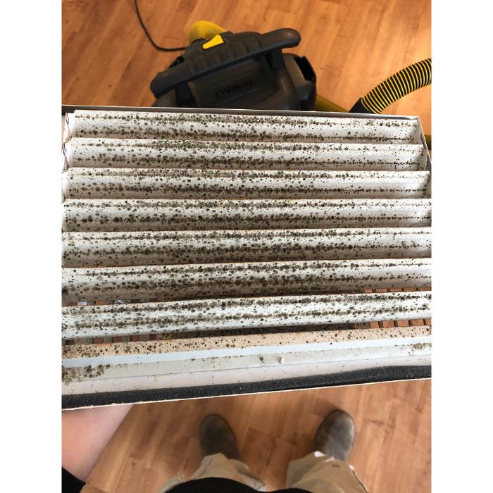 Close-up of a heavily used HVAC air filter showing why routine filter replacement is important for cleaner air and system efficiency.