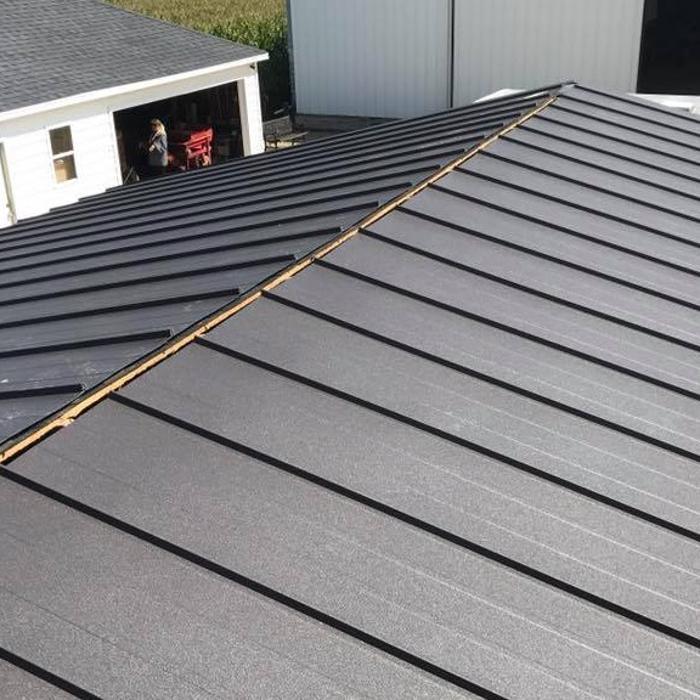 Standing seam metal roof installation in progress by MAS Roofing in Stephenson County IL. Premium metal roofing systems built to withstand Illinois winters and severe storm seasons.