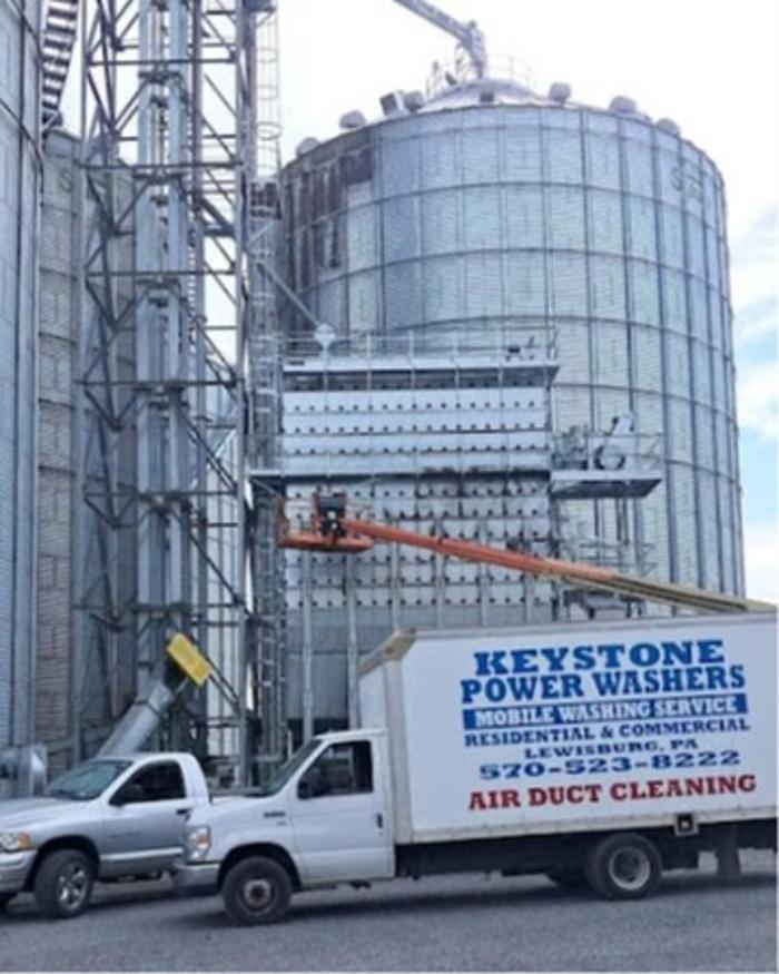 Power washing silage build up and sediment on farm silos in Lewisburg, PA.