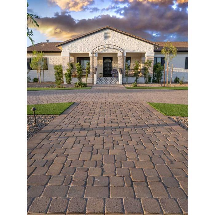 Custom paver walkway leading to a modern Arizona farmhouse with symmetrical green lawn strips and full curb appeal design.