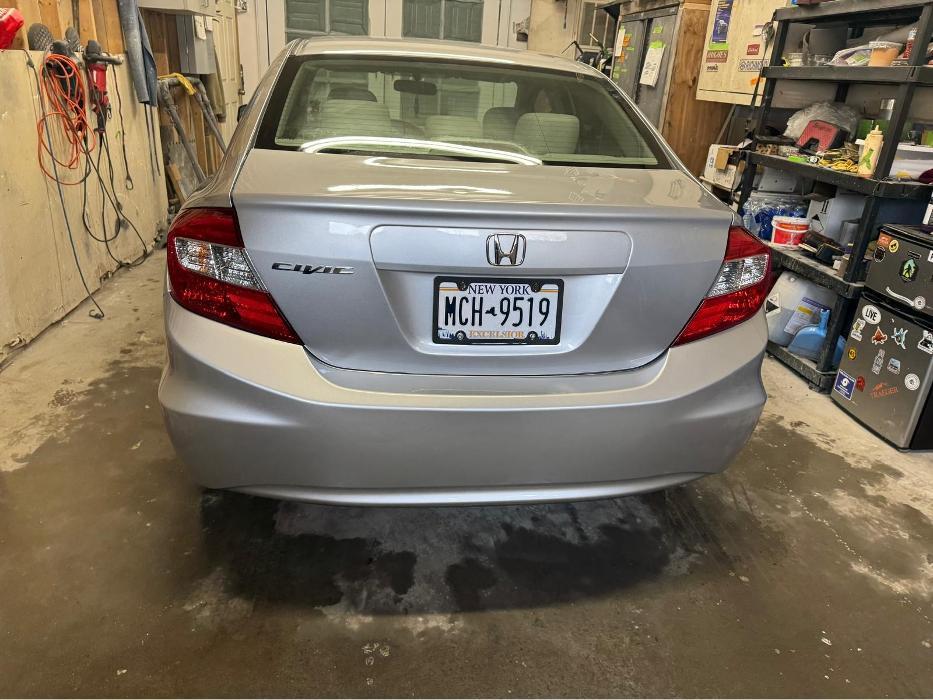 Vehicle inside shop during auto body repair and refinishing process.