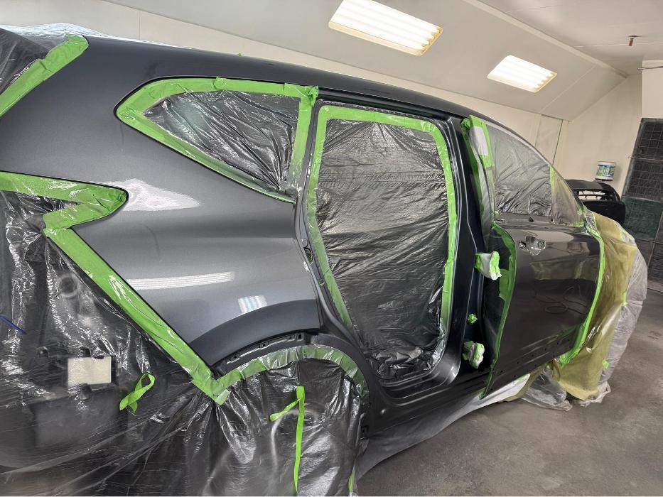 Vehicle masked and prepped for professional auto paint and refinishing service.
