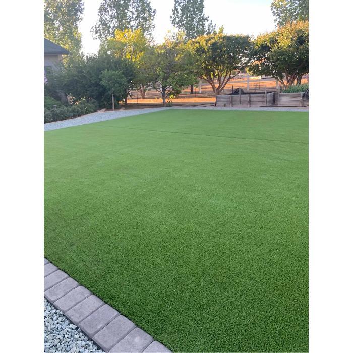 Freshly installed green lawn with clean brick edging and landscaped yard in Prescott Valley, Arizona