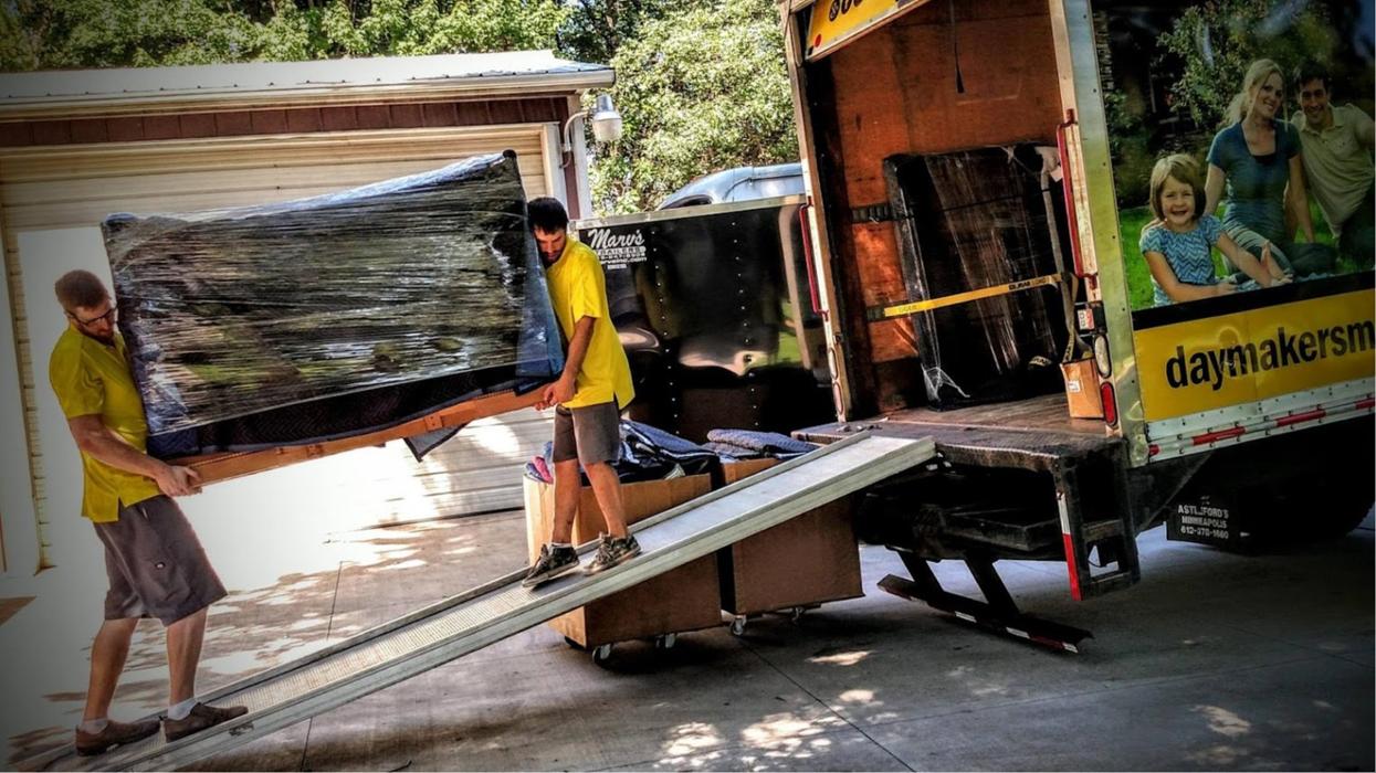 Daymakers Moving & Storage movers loading furniture into a truck at a Bloomington, MN home.