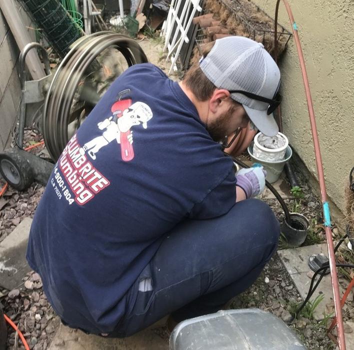 Plumb Rite Plumbing technician repairing an outdoor drain in Rancho Cucamonga, California