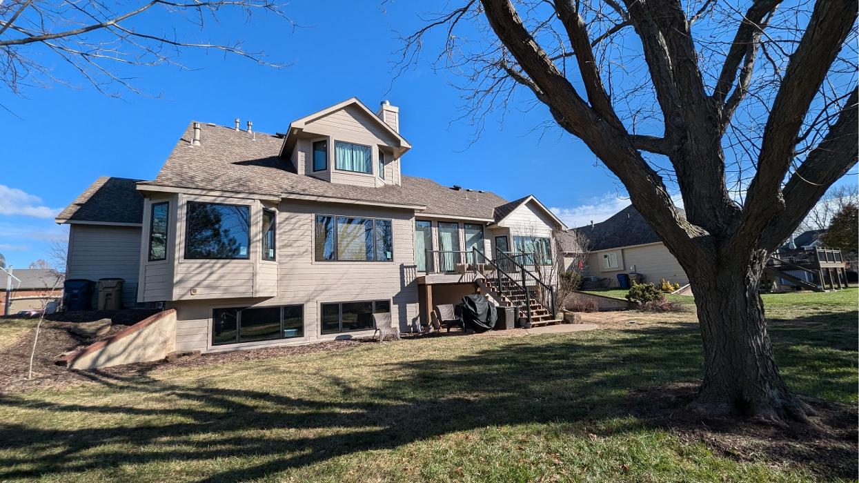 Wichita KS home exterior featuring updated siding and large window installation by Greenway Exteriors, improving energy efficiency and curb appeal
