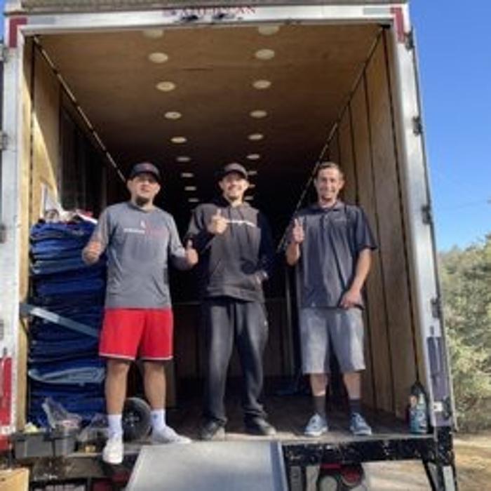 Maison Moving & Storage crew standing inside a moving truck in Tustin, California.