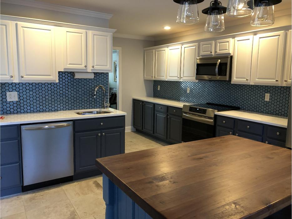 Kitchen remodel with blue cabinets and wood island countertop