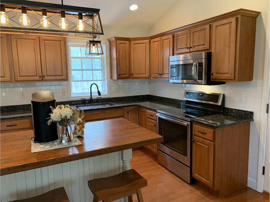 Kitchen remodel with wood cabinets and island seating