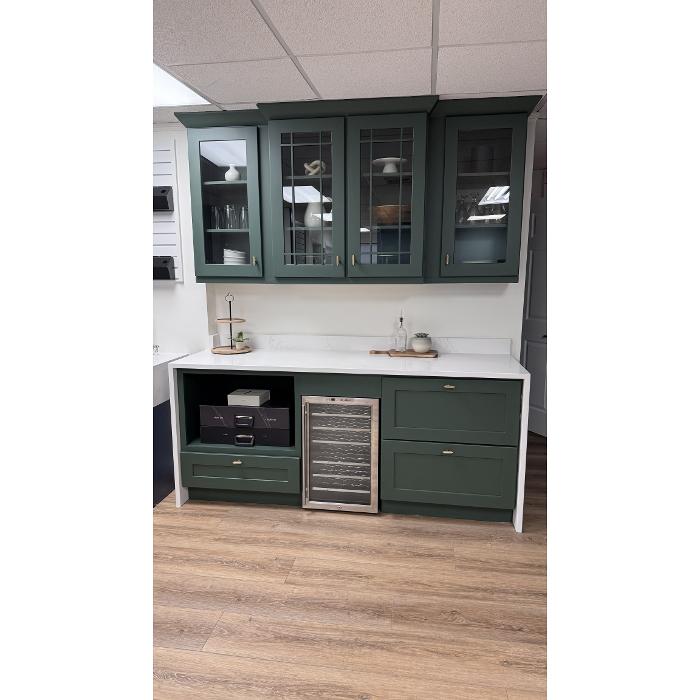 Custom green built-in cabinets with glass doors and wine cooler