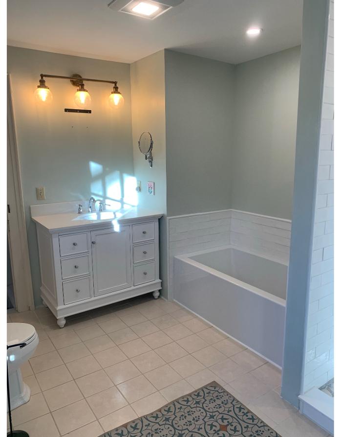 Bathroom remodel with white vanity and soaking tub