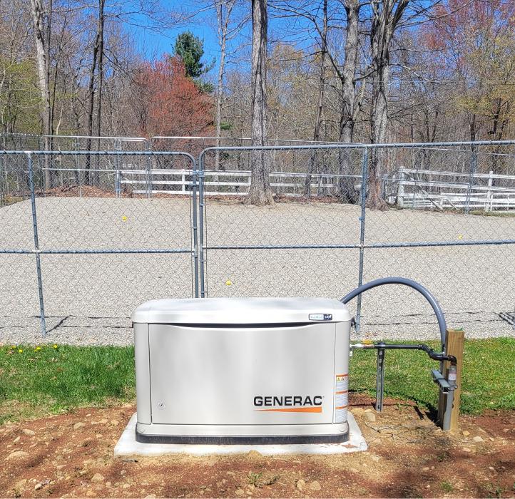 Outdoor Generac standby generator on concrete pad