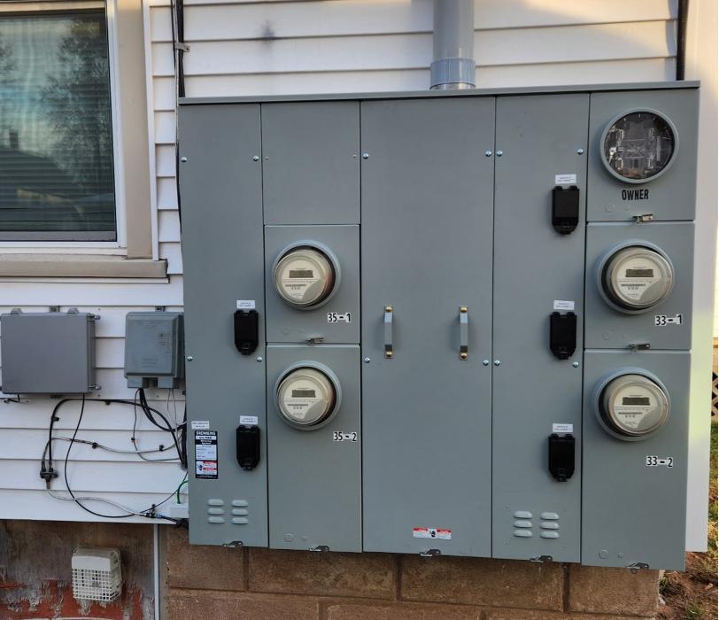 Multi-meter electrical service installation on exterior wall