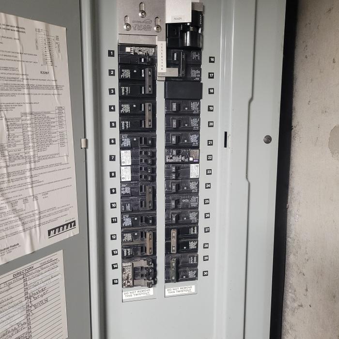 Electrical breaker panel with generator interlock