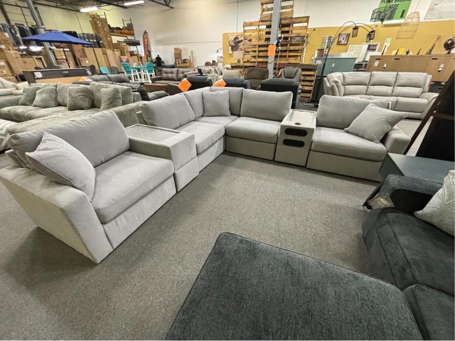 Light gray sectional sofa with console at Furniture & Cabinet Outlet in West Chester Township, Ohio.