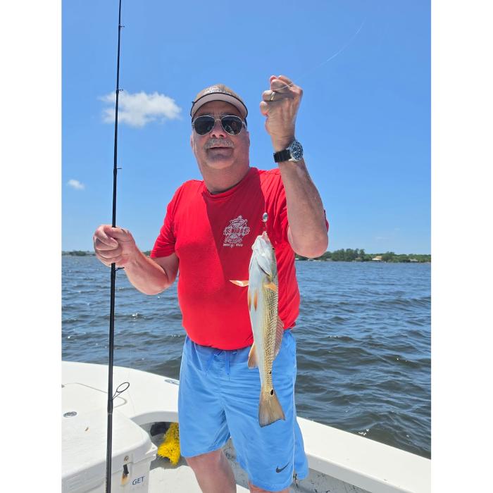 Showintail Inshore Charters guest holding a redfish in Navarre, Florida