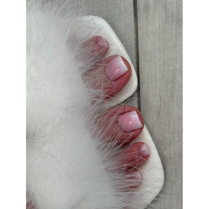 Pink French ombr&eacute; pedicure with glossy square toenails and white fluffy sandals at Logunova Beauty Salon