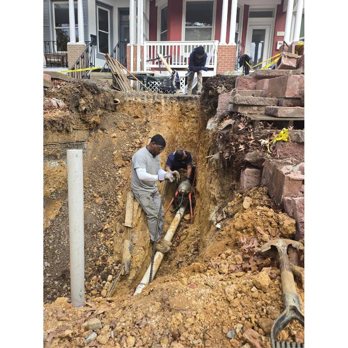 Jimmy Gusky crew excavating outdoor piping for HVAC service at a Washington, DC rowhouse.