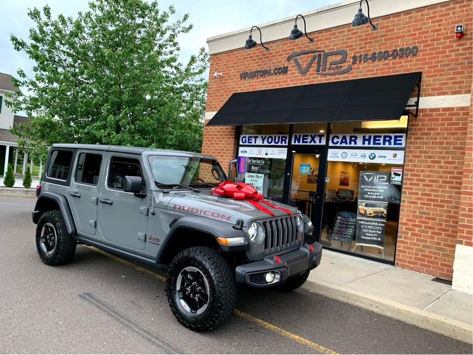 Gray Jeep Wrangler with a red bow outside VIP Auto PA in Feasterville-Trevose, Pennsylvania.