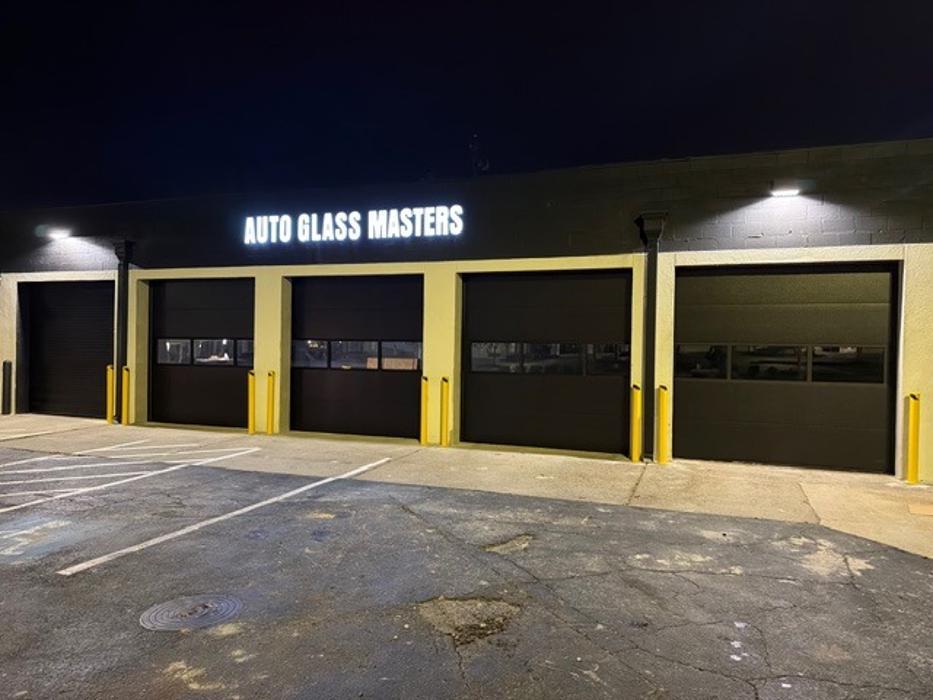 Commercial-style glass and aluminum storefront garage door installation in Atlanta, GA — Hawk Garage Doors
