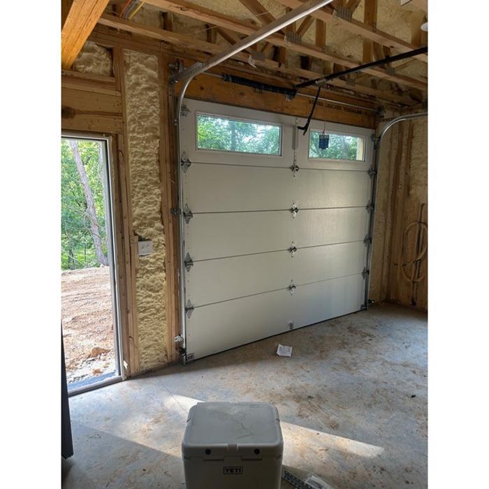 Custom wood-look garage door with glass panel inserts and modern framing — Hawk Garage Doors