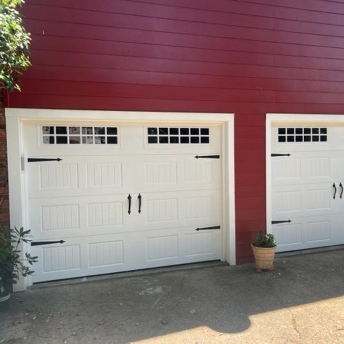 Modern white raised-panel garage door with dark wood accent trim installed on a contemporary Atlanta home — Hawk Garage Doors