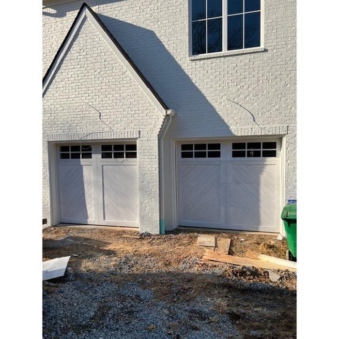 White carriage-style garage door with black hardware installed on a traditional home in Atlanta, GA — Hawk Garage Doors