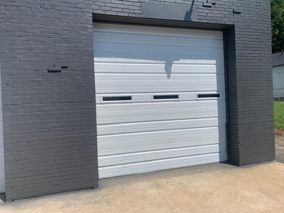 Classic white car garage door with decorative hardware and raised panel design — Hawk Garage Doors