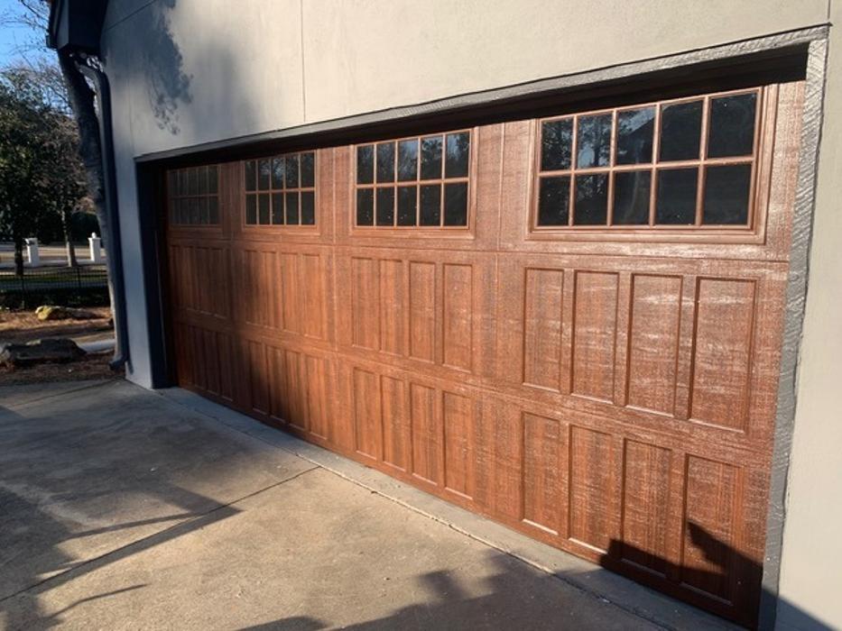 Cedar wood-tone garage door with glass window panels installed on a home in Atlanta — Hawk Garage Doors