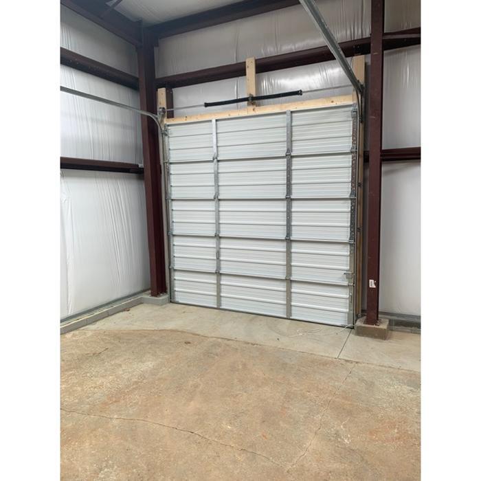 Full-view frameless glass and aluminum garage door installation for a commercial or residential property — Hawk Garage Doors
