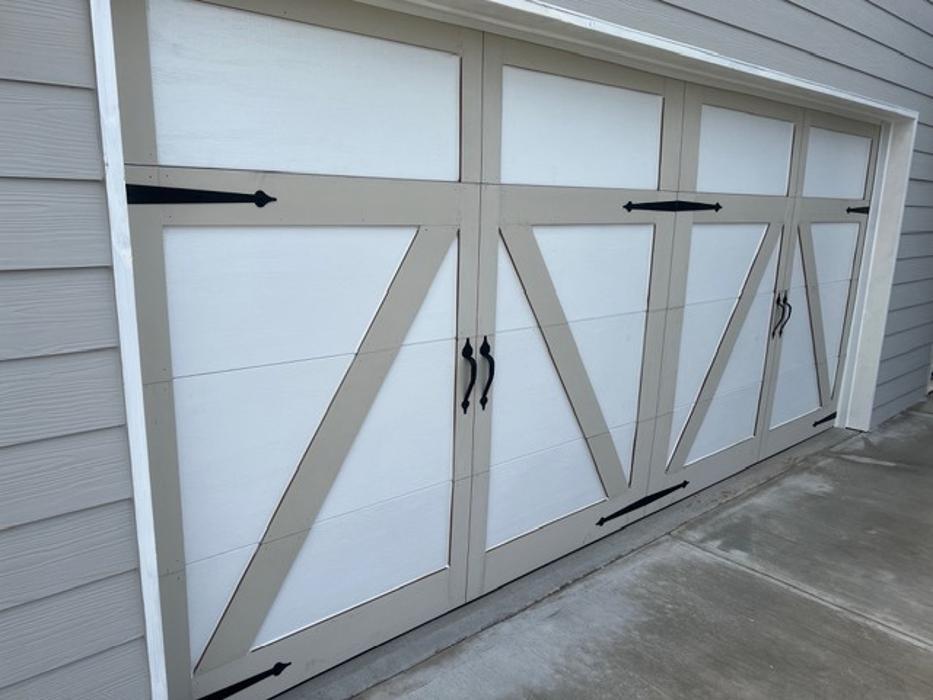 Carriage-house style garage door with bold X-brace and crossbuck detailing in gray finish — Hawk Garage Doors